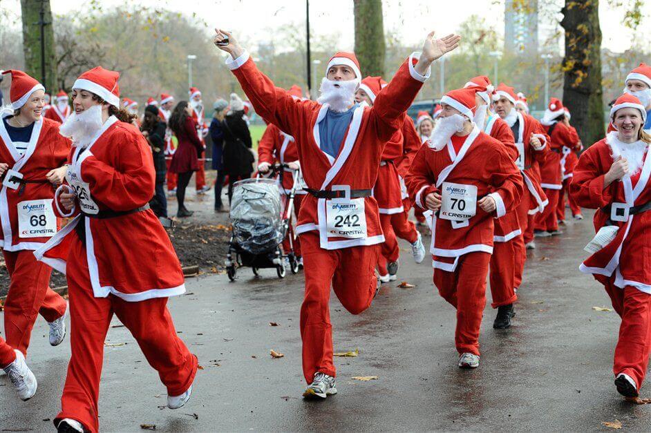 People dressed as Santa taking part in a festive running event in London